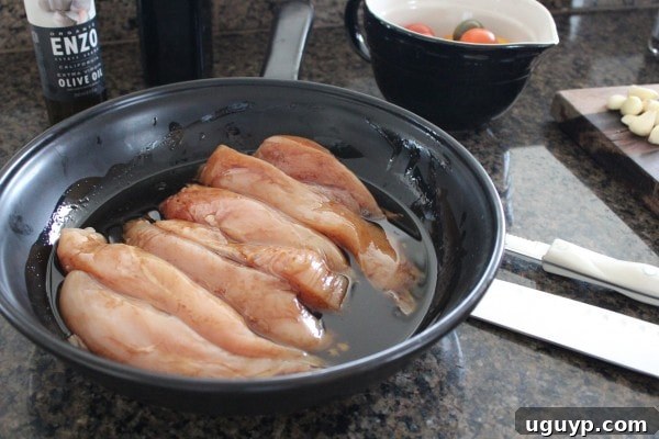 Pouring Balsamic and Olive Oil Mixture Over Chicken