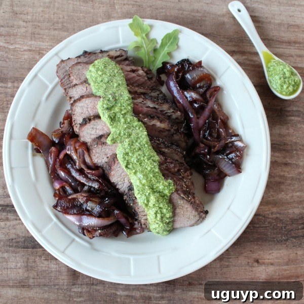 Walnut Crusted Tri Tip with Arugula Pesto - A close-up of a tri-tip steak with a beautiful walnut, rosemary, and garlic crust, ready for grilling.