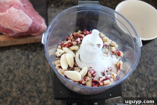 Walnut Crusted Tri Tip Prep - Walnuts, rosemary, garlic, salt, and pepper in a food processor, ready to be blended for the crust.