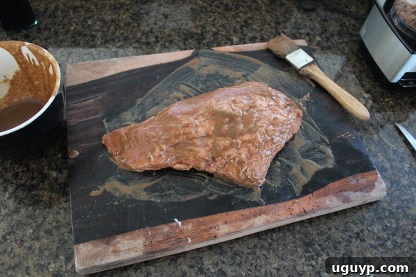 Balsamic Tri Tip Recipe - A tri-tip steak being brushed with the balsamic and dijon marinade.