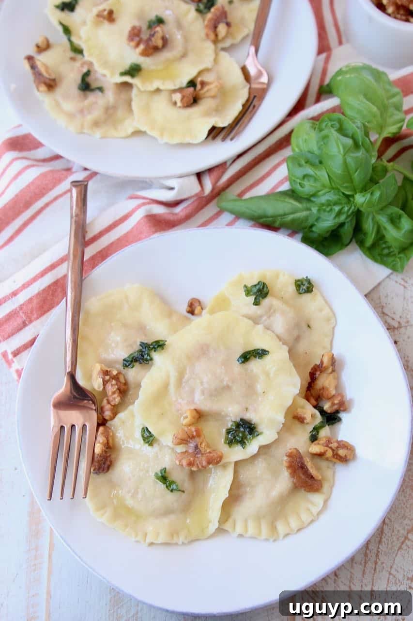 Overhead shot of raviolis on two plates with copper fork