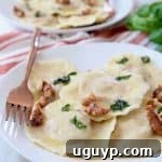 Raviolis on white plate with copper fork on the side
