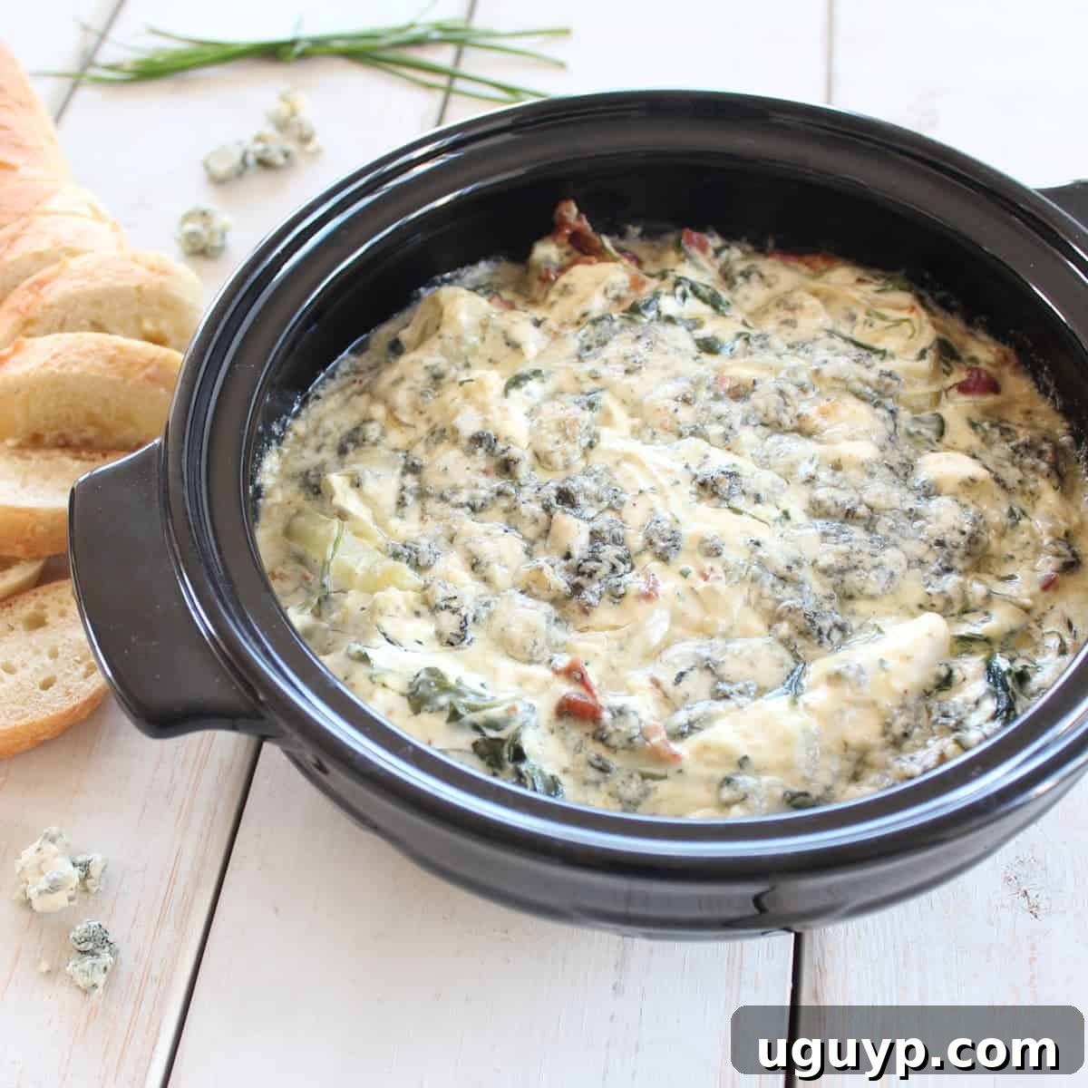 Warm Blue Cheese Bacon Spinach Dip with a sliced baguette