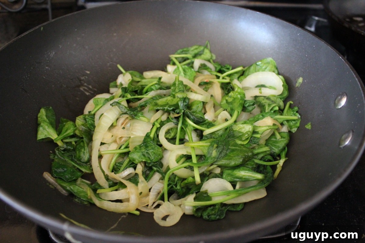 Caramelized onion and spinach in a pan