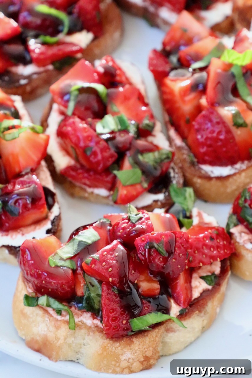 Fresh strawberry bruschetta on toasted baguette slices arranged beautifully on a plate, ready to be served as a delightful appetizer.