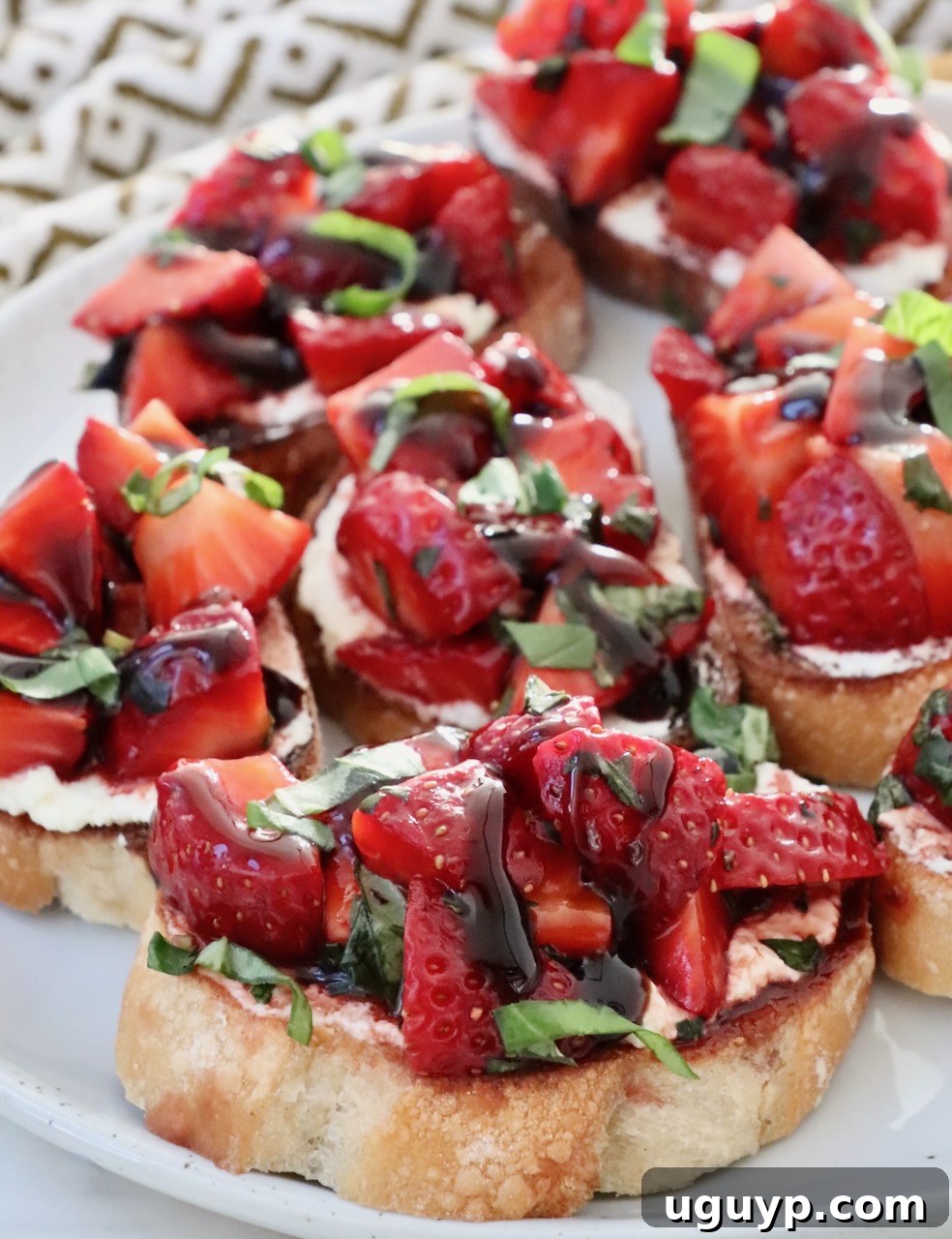 A close-up of a plated strawberry bruschetta, showcasing the vibrant colors and appealing textures of the fresh ingredients.
