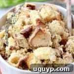 Gluten free stuffing in oval serving bowl with serving spoon