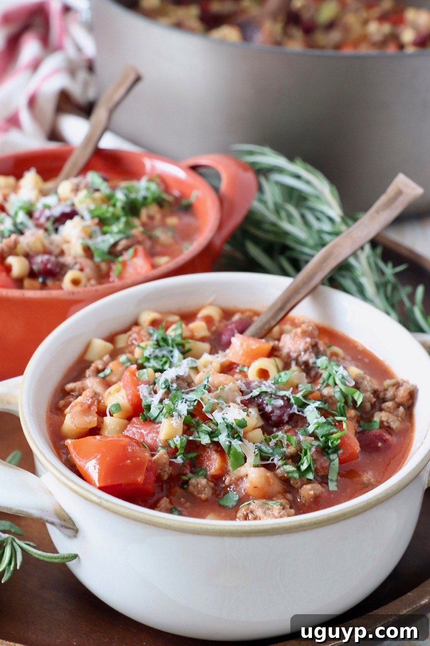 Two bowls of Pasta Fagioli soup with spoons, ready to be enjoyed.