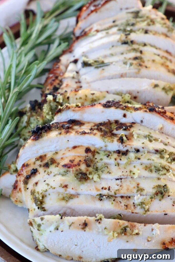 sliced turkey on plate with fresh rosemary