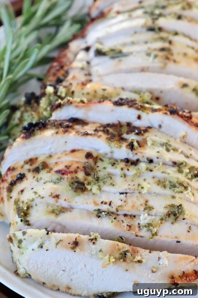 slices of turkey on a plate with fresh herbs