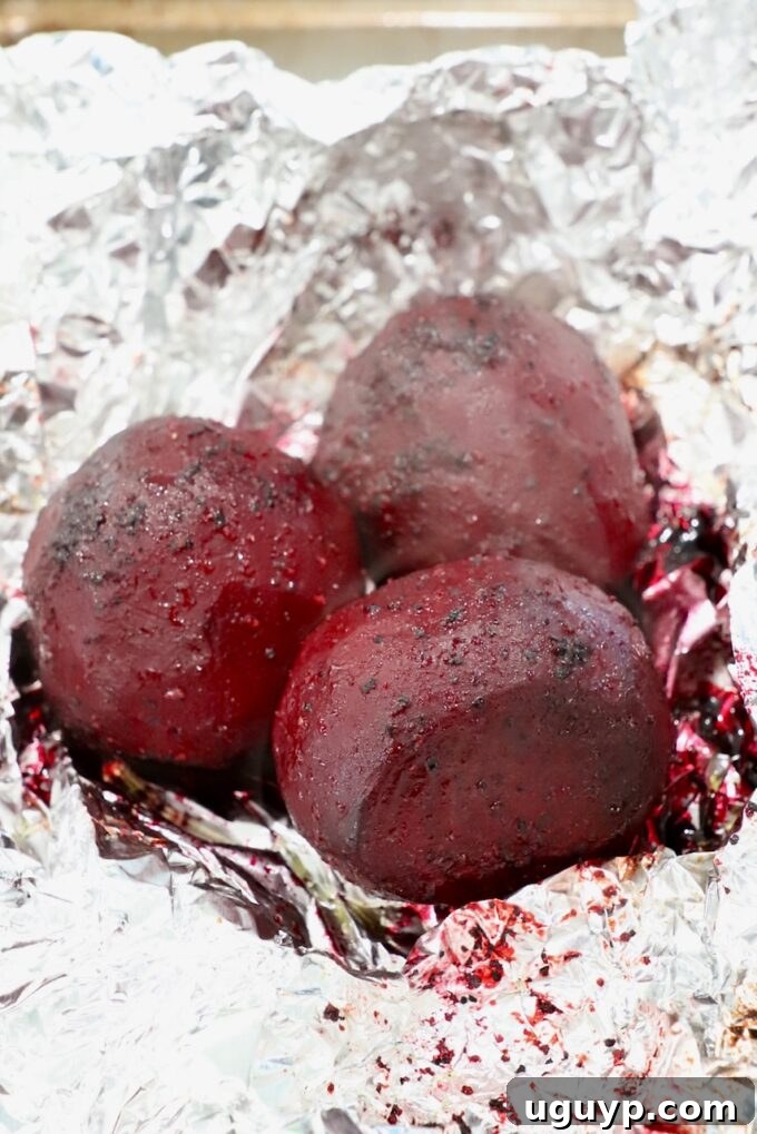 Perfectly roasted beets, unwrapped from foil, showcasing their tender texture and rich color.