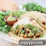 Butternut Squash tacos with creamy avocado sauce and fresh cilantro on flour tortillas