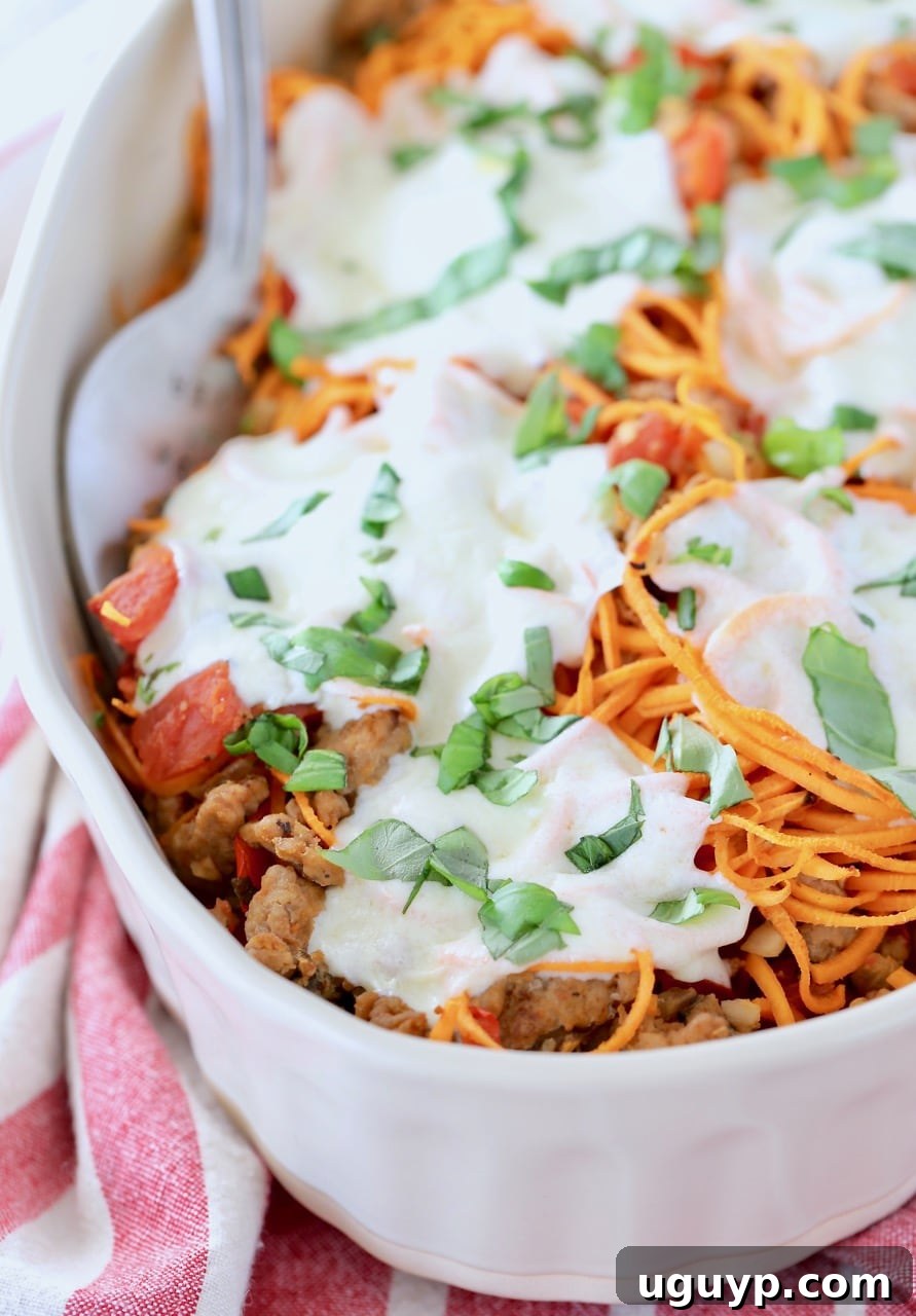 Italian turkey sweet potato casserole in oval baking dish with large serving fork