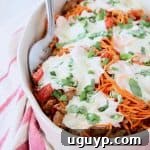 Italian casserole with sweet potato noodles and mozzarella cheese in oval white baking dish
