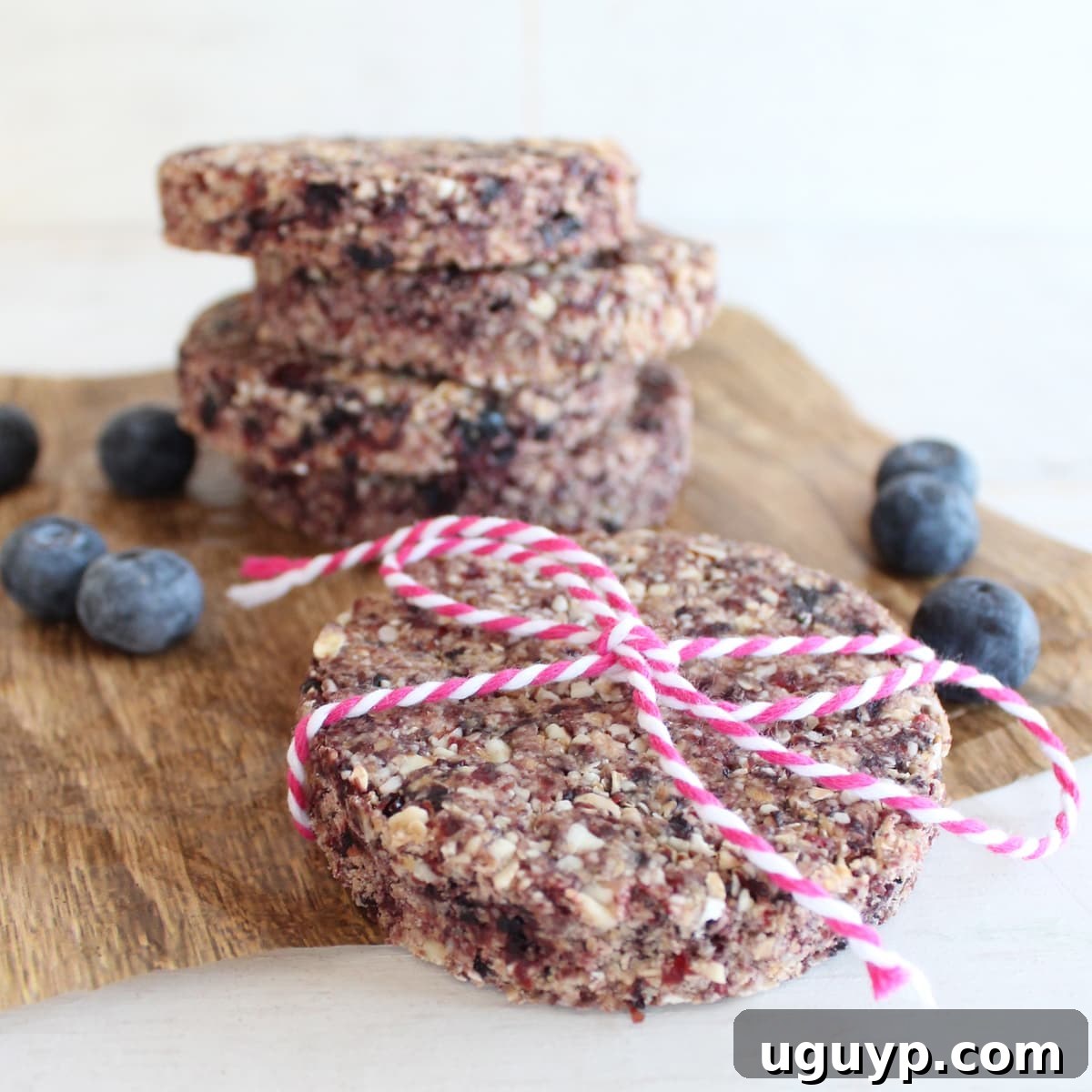 Freshly baked and sliced oatmeal berry granola bars arranged on a platter, some cut into circles.