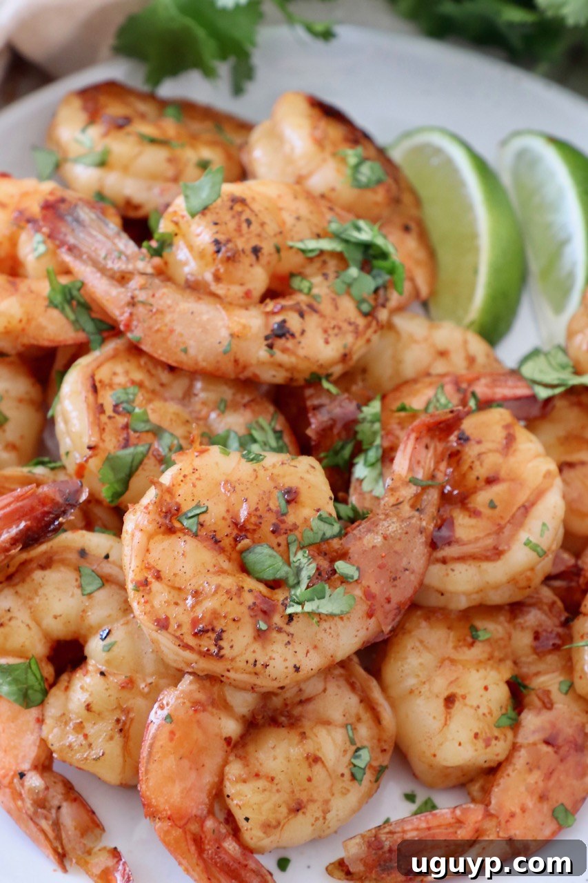 Close-up of marinated cooked shrimp garnished with fresh cilantro on a plate