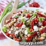 Quinoa salad in bowl with feta cheese, sun dried tomatoes and chickpeas