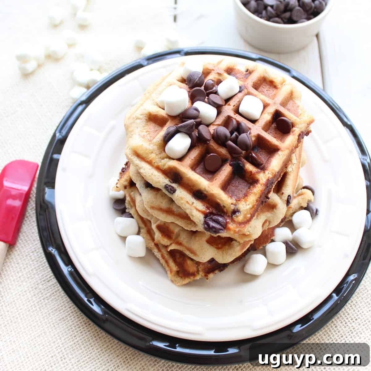 Stacked S'mores Waffles with chocolate chips and mini marshmallows on top