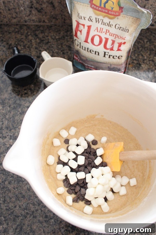 Adding chocolate chips and mini marshmallows to Gluten Free S'Mores Waffle batter