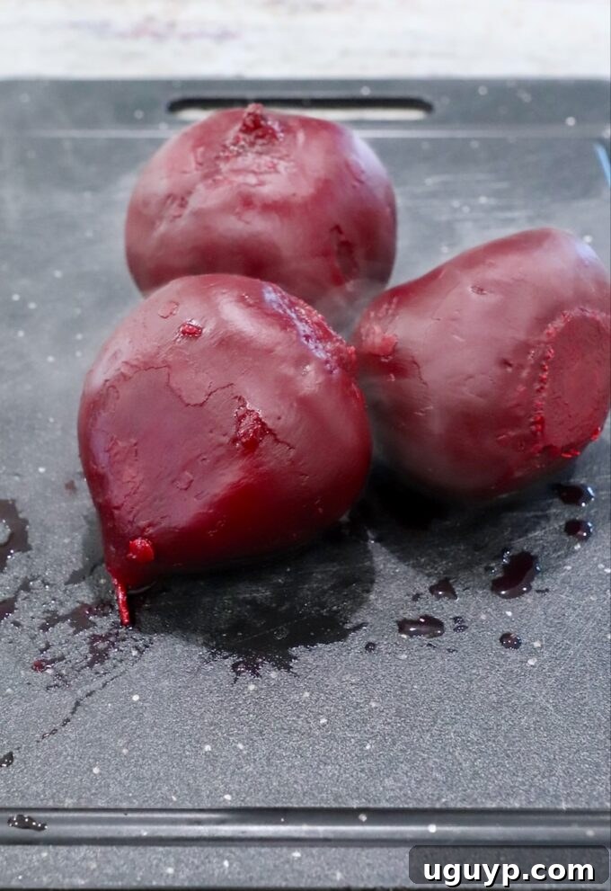 Peeled and diced steamed beets on a cutting board, ready for the food processor.