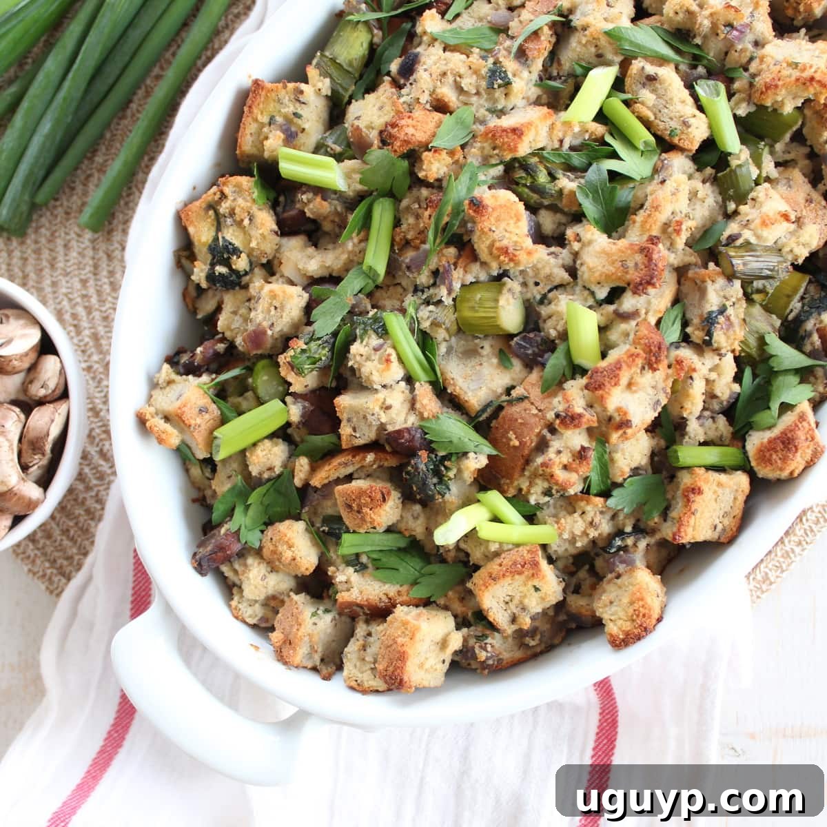 Gluten Free Spring Vegetable Stuffing, beautifully presented in a baking dish with fresh herbs