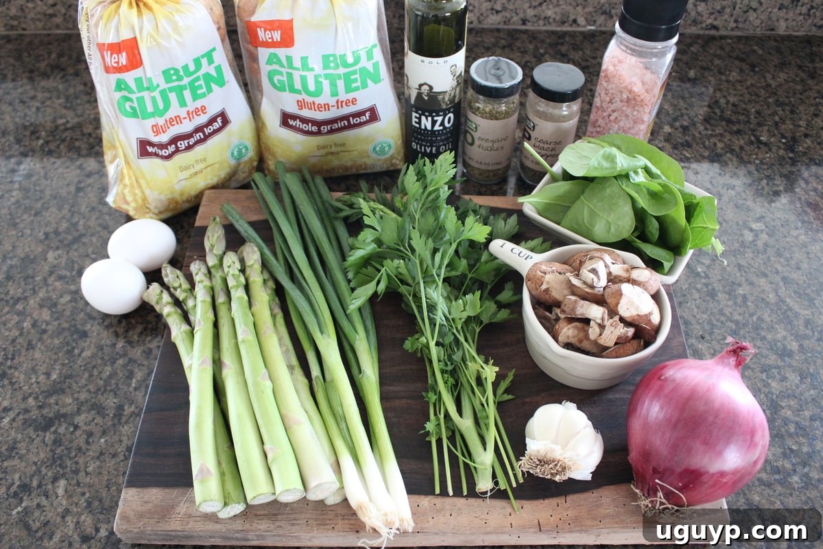 Fresh ingredients for Gluten Free Vegetable Stuffing laid out on a rustic wooden board, including gluten-free bread cubes, asparagus, spinach, mushrooms, and herbs