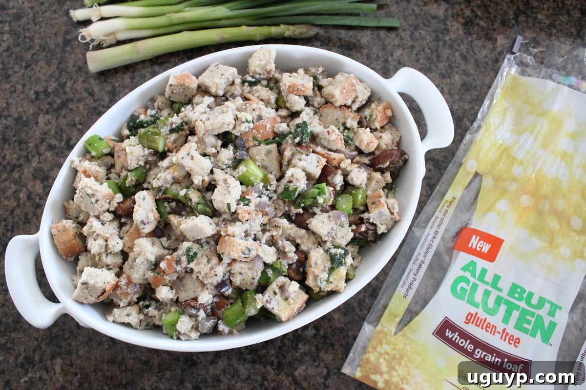 Gluten-free vegetable stuffing mixture gently tossed and placed into an oven-safe baking dish, ready for baking