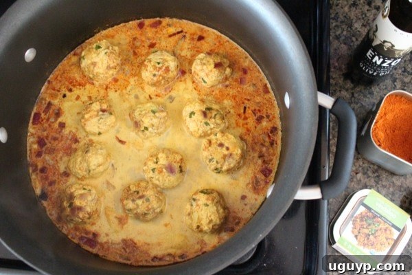 Covered pot showing Chicken Curry Meatballs simmering to perfection in the Vindaloo sauce