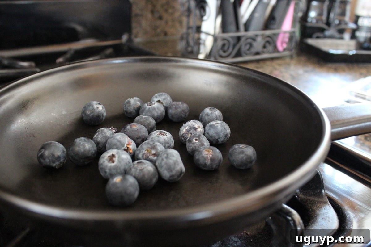 Blueberries simmering in a saucepan for the homemade BBQ sauce.