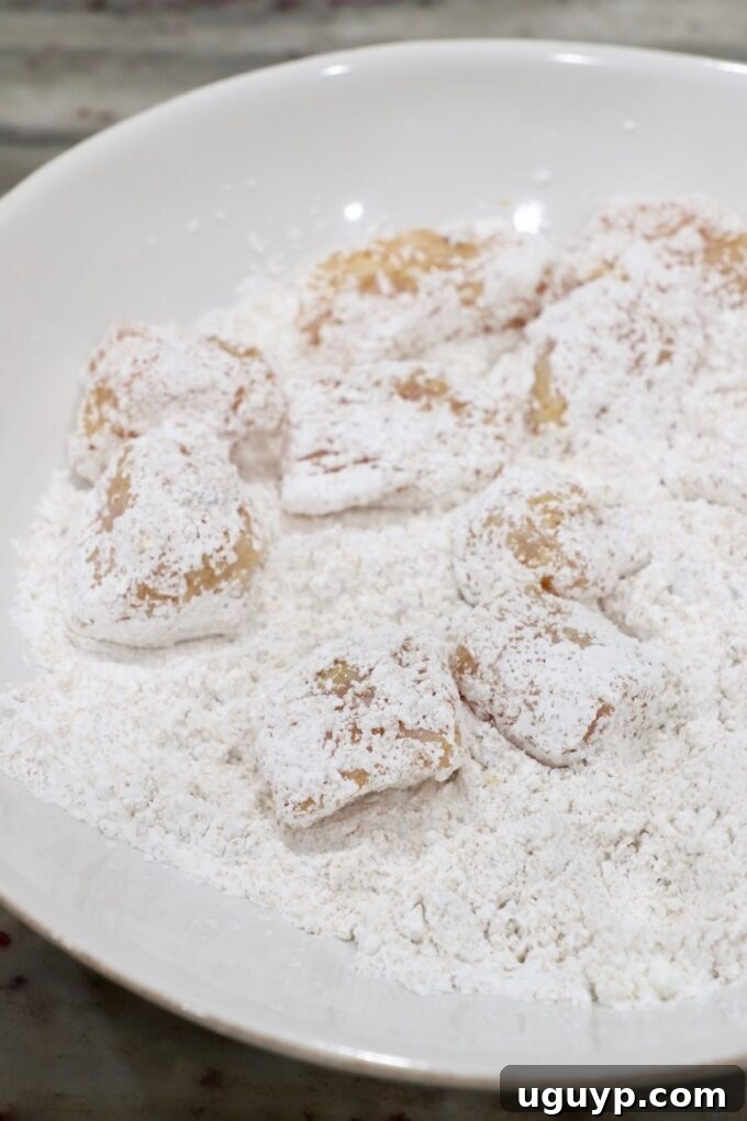 cornstarch coated pieces of chicken in a bowl