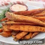 Close-up of crispy baked sweet potato fries, perfectly golden and seasoned.