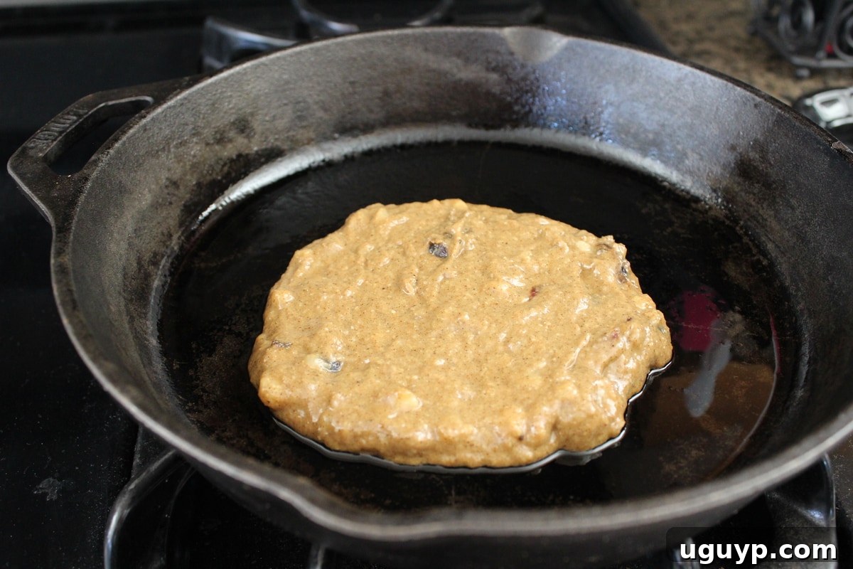 Pouring pancake batter onto a hot skillet