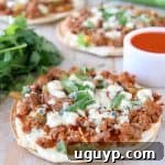 Grilled tortilla topped with buffalo sauce ground turkey and blue cheese