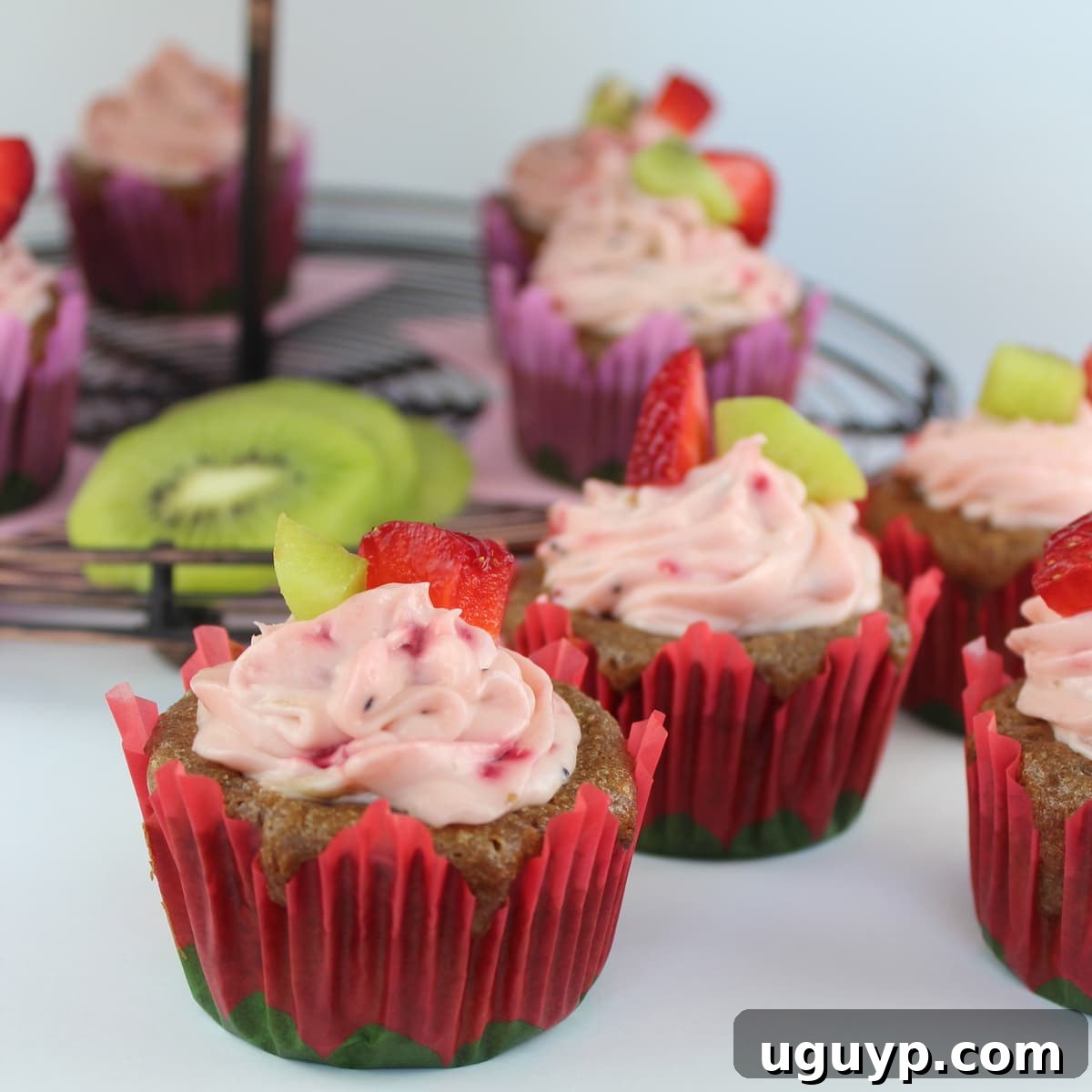 Delicious Strawberry Kiwi Cupcakes topped with creamy frosting and fresh fruit slices