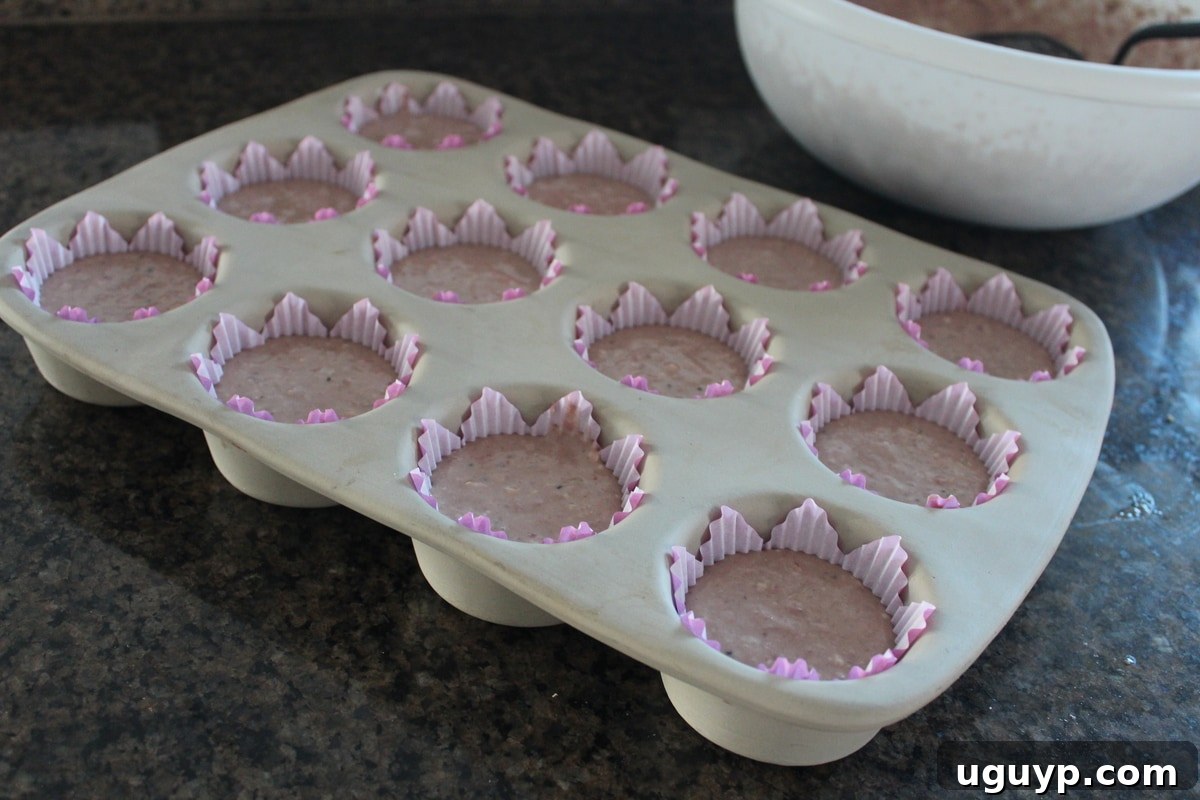 Unbaked Strawberry Kiwi Cupcakes in a muffin pan, ready for the oven