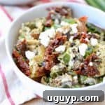 Greek eggs in bowl with feta cheese, sun dried tomatoes and green onions