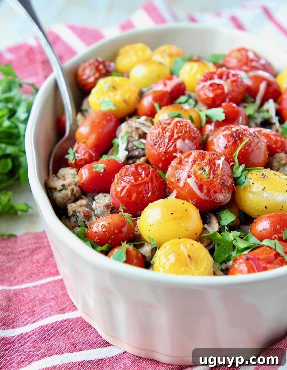 Ground turkey casserole topped with heirloom cherry tomatoes and chopped fresh parsley