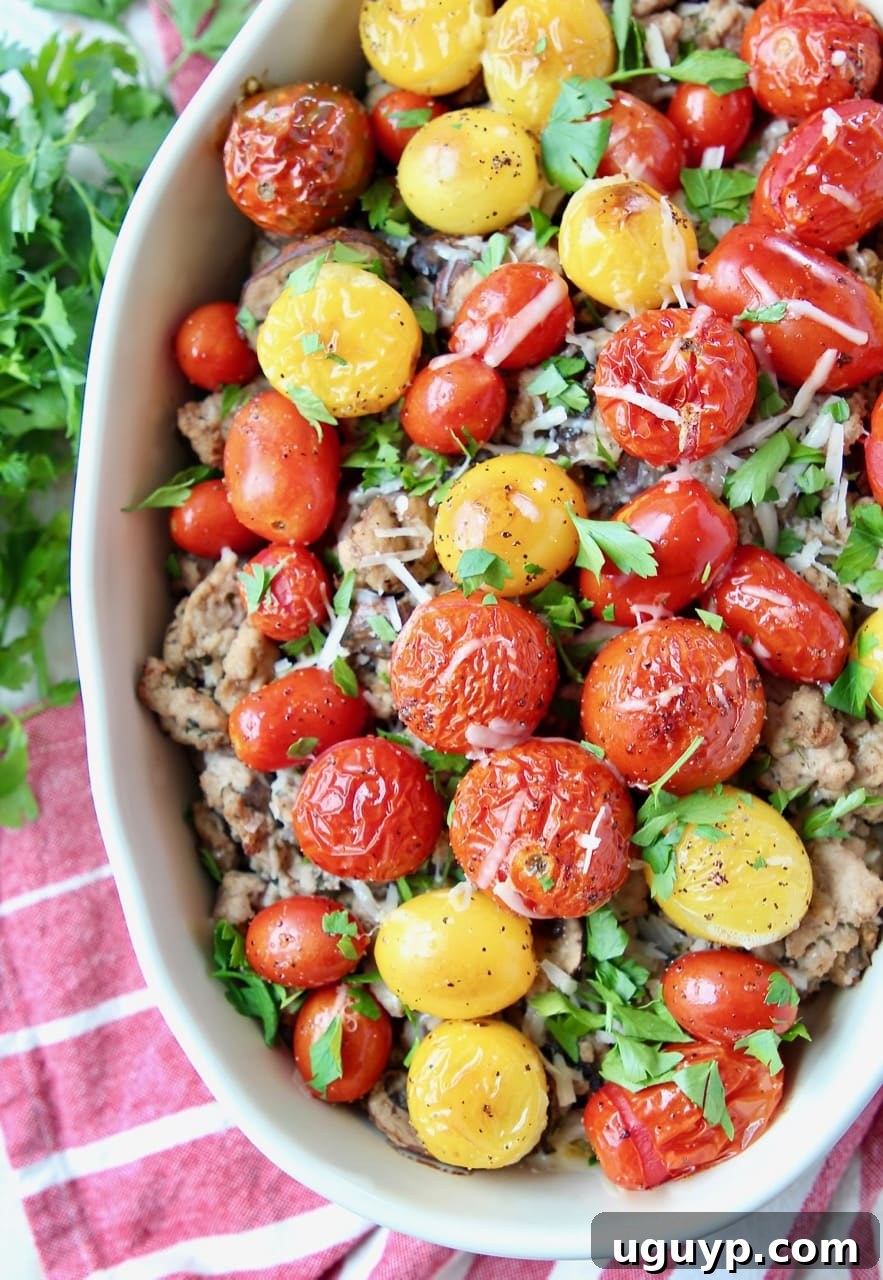 Casserole dish filled with Italian ground turkey, roasted cherry tomatoes and chopped parsley