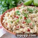 Mexican rice with tomatoes, topped with fresh cilantro in orange bowl