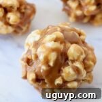 Peanut Butter Popcorn Balls on a white marble serving tray, beautifully presented.