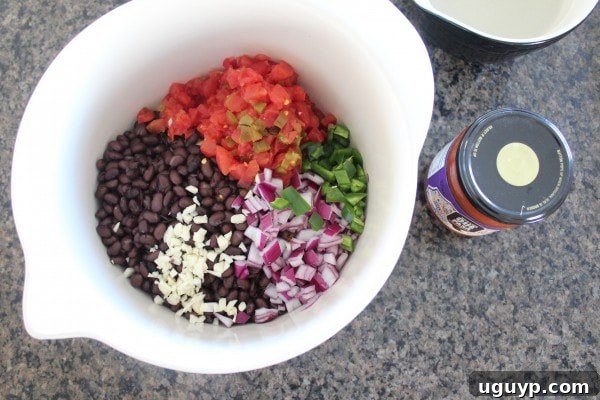 Mexican Chipotle Sweet Potato Casserole Recipe - mixing the fresh vegetables and beans.