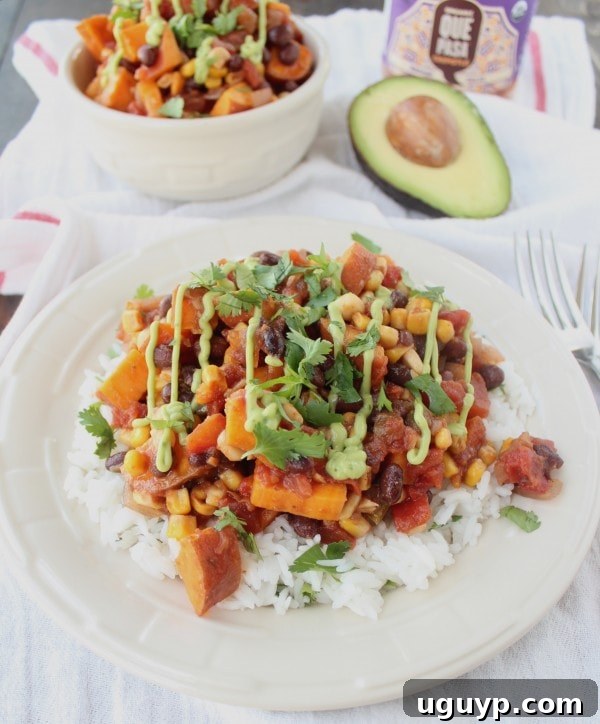 Gluten-Free Chipotle Sweet Potato Casserole drizzled with fresh avocado sauce.
