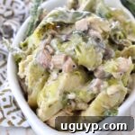 A rustic image of a cooked brussel sprout casserole in a white serving bowl, garnished minimally, ready for presentation.
