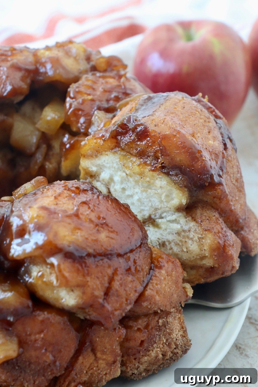 Delicious Pumpkin Apple Monkey Bread served on a plate with a spatula, ready to be enjoyed.