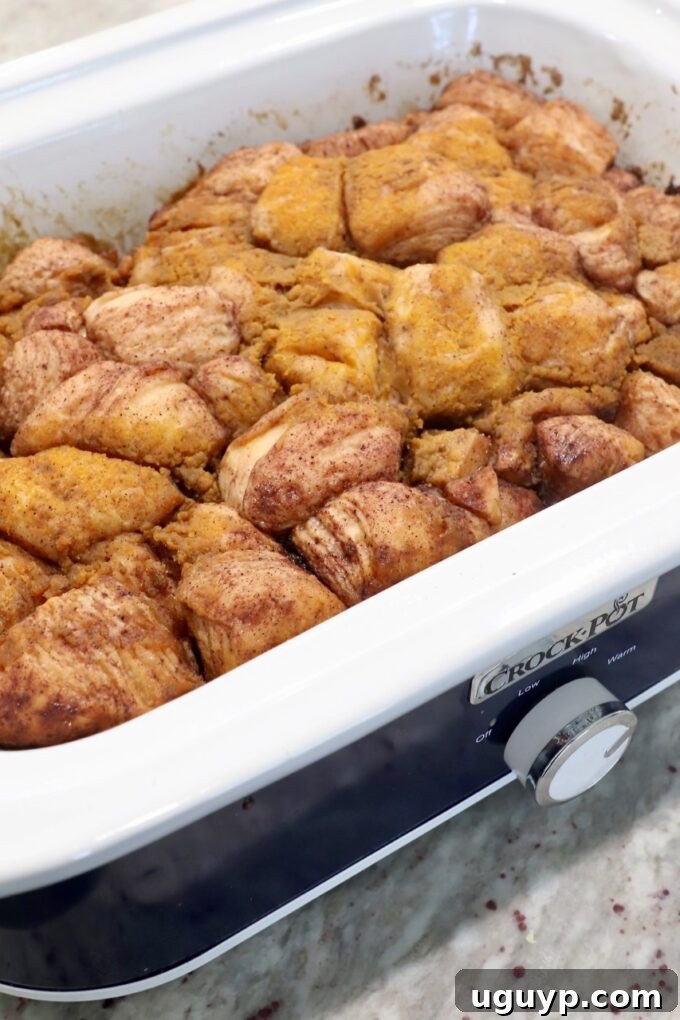 Cooked pumpkin apple monkey bread in a slow cooker, golden brown and ready to serve.