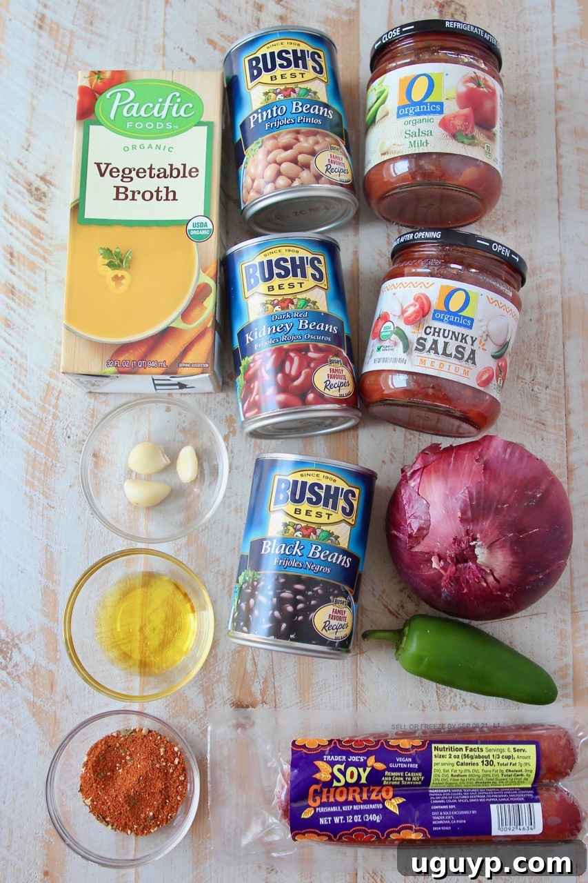 A colorful array of fresh ingredients for making vegan chili, including beans, soyrizo, vegetables, and jars of salsa.