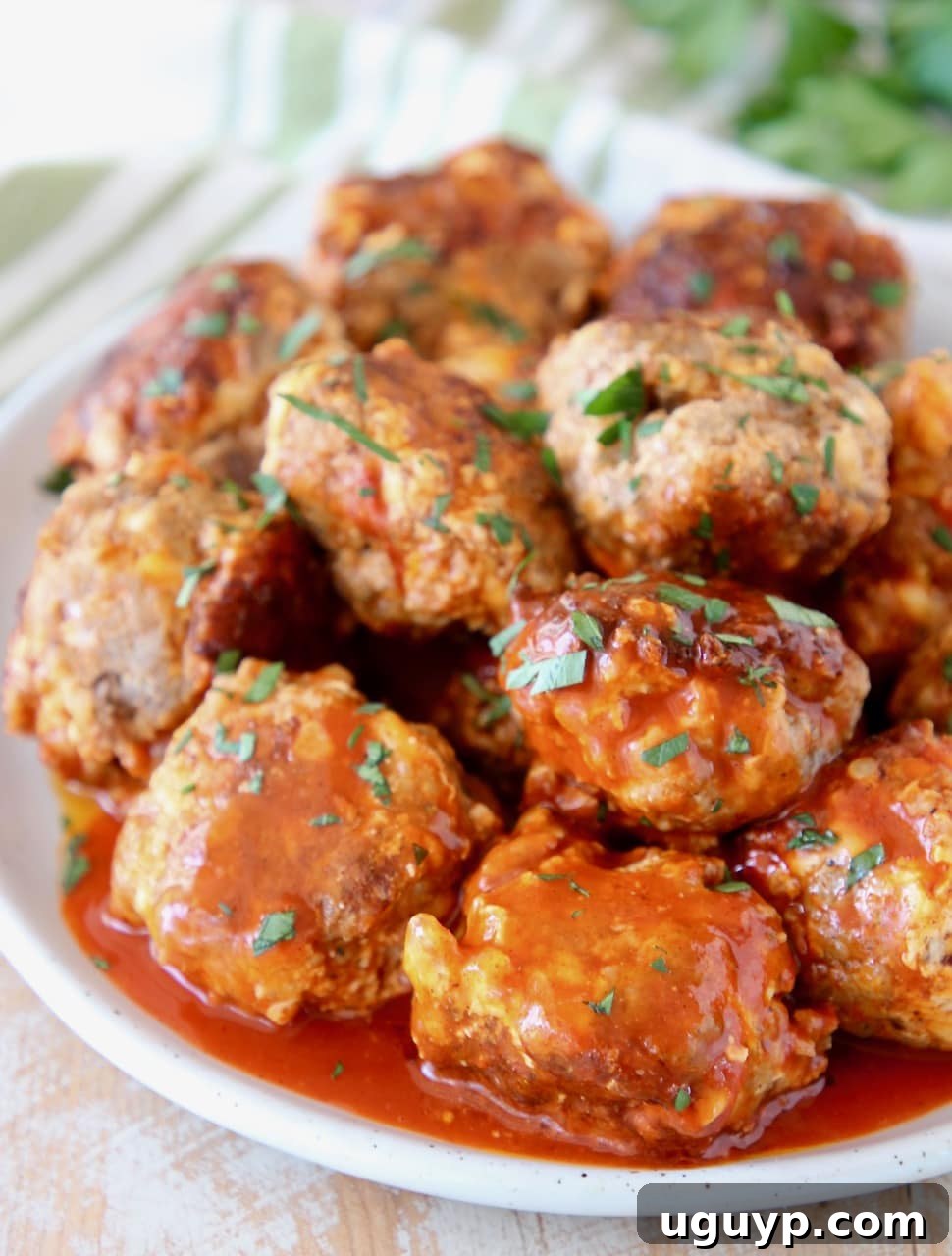 Cheesy Sausage Balls covered in Buffalo Sauce with Fresh Cilantro