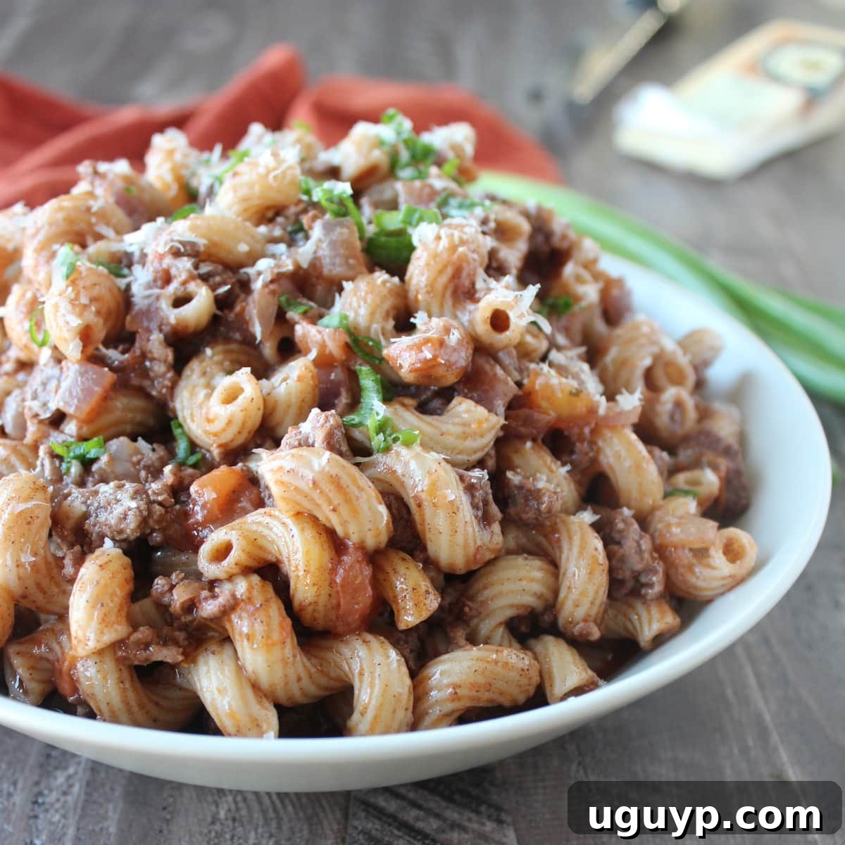 A comforting bowl of cooked macaroni and ground beef, generously seasoned with Mediterranean spices, ready to be enjoyed as a quick and delicious one-pot dinner.