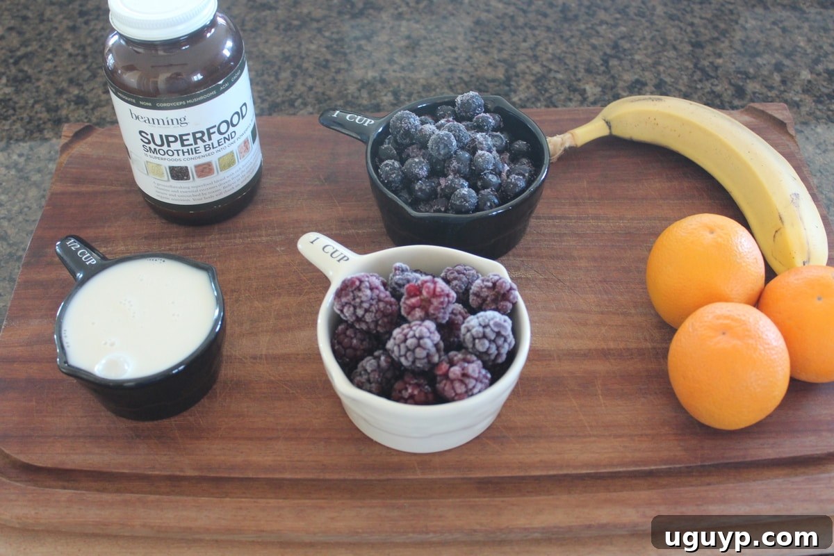Fresh ingredients for Orange Berry Immunity Boosting Smoothie laid out