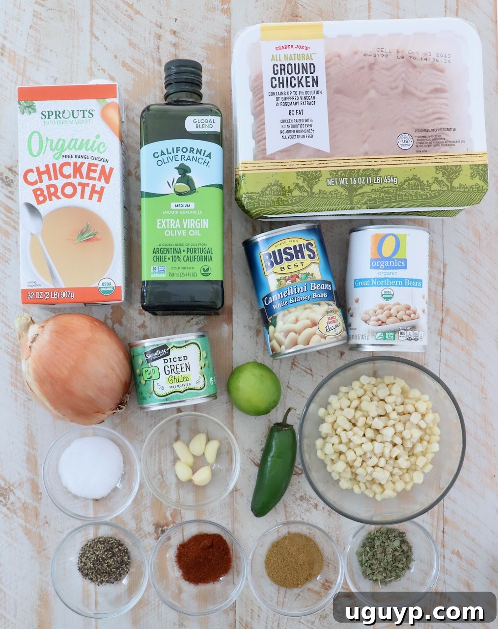 ingredients for white chicken chili on white wood board